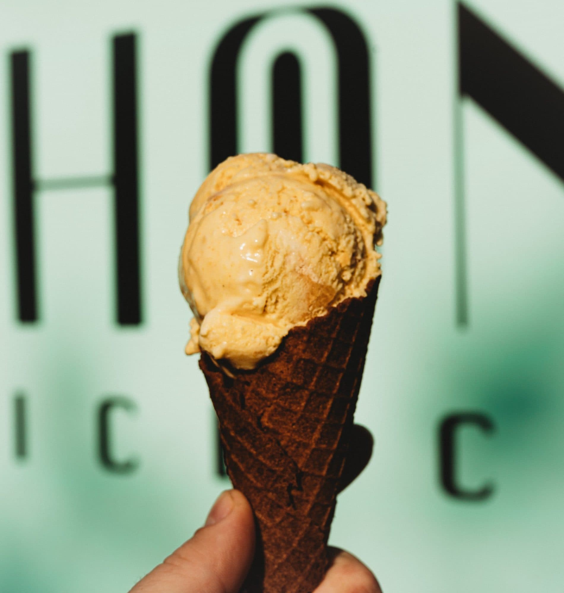 Honeybean ice cream cone in front of the Honeybean sign